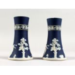 A PAIR OF ADAM'S BLUE AND WHITE JASPER WARE SPILL VASES. 6ins high.