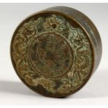 A CHINESE CIRCULAR BOX AND COVER inset with a coin design. 3ins diameter.