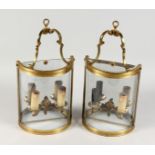 A PAIR OF BRASS AND GLASS BOWFRONT TWIN BRANCH ELECTRIC WALL LIGHTS. 15ins high x 8ins wide.