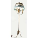 AN ORNATE BRASS STANDARD LAMP. with eagle finial, three curving branches, reeded column on three