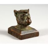 A BRONZE MINIATURE MONKEY HEAD SEAL. 1.25ins wide.