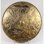 A LARGE EUROPEAN GILDED METAL CIRCULAR CHARGER depicting a battle scene. 25ins diameter.