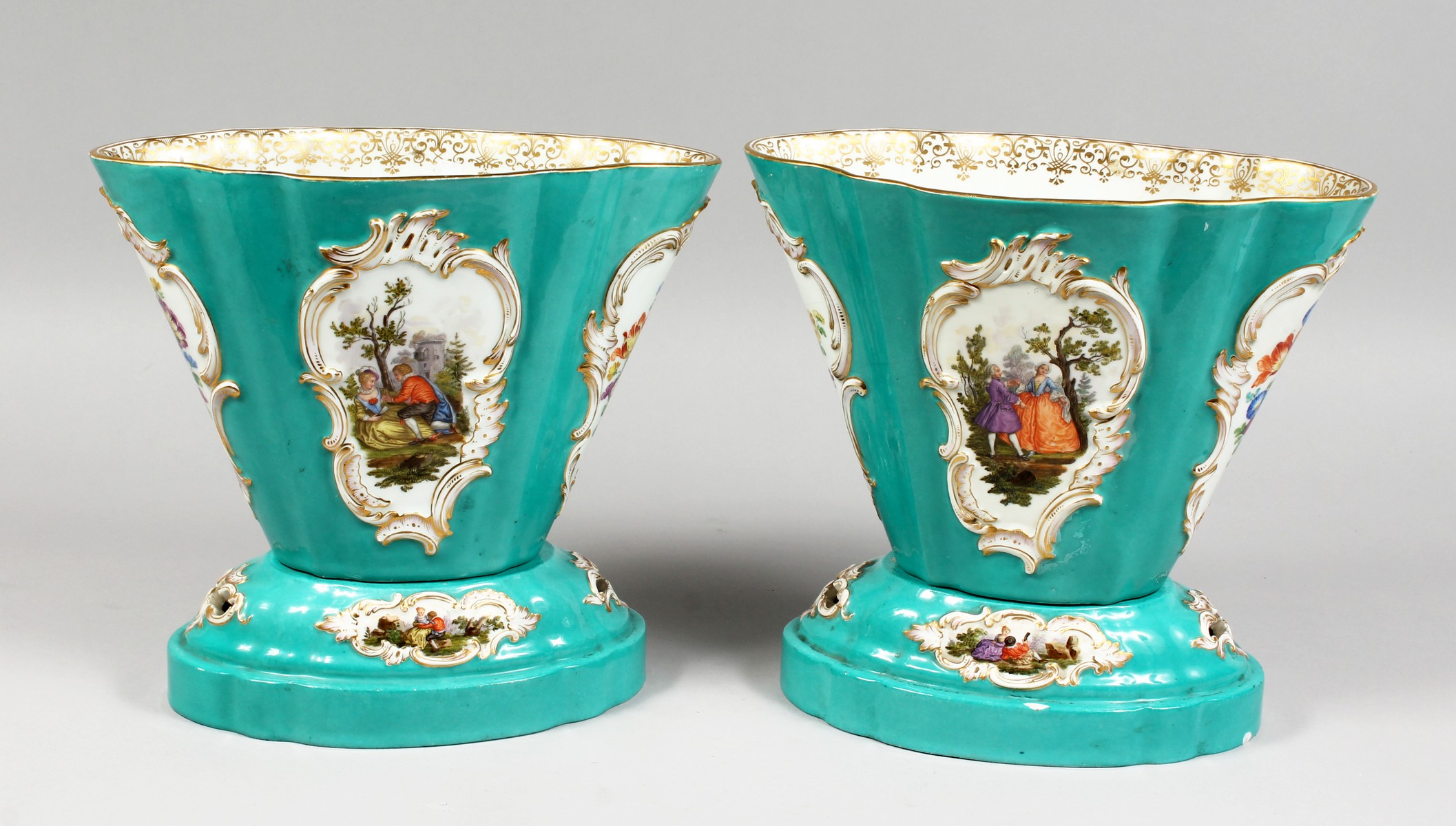 A VERY GOOD PAIR OF EARLY 19TH CENTURY MEISSEN OVAL TAPERING VASES ON STANDS, painted with panels of