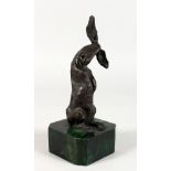 A SMALL ABSTRACT BRONZE OF A HARE, mounted on a marble base. 8.5ins high.