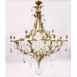 A LARGE AND IMPRESSIVE BRASS AND CUT GLASS TWELVE LIGHT CHANDELIER, with cut glass parts, prism