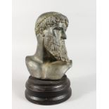 AFTER THE ANTIQUE. A ROMAN POTTERY BUST on a circular wooden base. 8ins high.