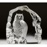 AN INTAGLIO ENGRAVED GLASS ORNAMENT modelled as an owl on a rock, signed. 6ins high.