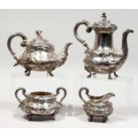 A GOOD VICTORIAN SILVER FOUR PIECE TEA SET with repousse decoration on claw feet, comprising teapot,