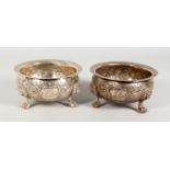 AN EARLY PAIR OF 19TH CENTURY SILVER CIRCULAR BOWLS, POSSIBLY JAMAICAN, repousse decoration with