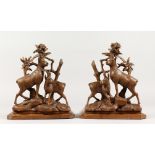 A GOOD PAIR OF BLACK FOREST CARVED WOOD DEER BOOKSTANDS. 11ins high.