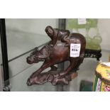 A Chinese carved wood figure of a boy on a water buffalo.