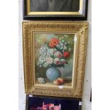 A still life of flowers in a vase with fruit, oil on canvas in a decorative gilt frame.