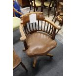 An Edwardian mahogany swivel armchair.