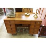 A Heal's walnut kneehole dressing table with lift-up mirror.