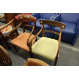 Two 19th century mahogany dining chairs with arms.