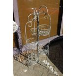 A wrought iron folding plant pot stand.