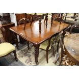 A good Victorian style mahogany extending dining table with one leaf.