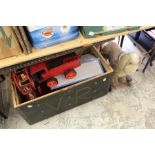 A trunk containing various wooden toys together with a push-along dog toy.