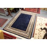 A Persian design rug, blue ground with a decorative border.