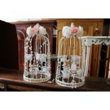 A pair of bird cage style tea light holders.