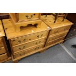 A pair of pine three drawer chests.