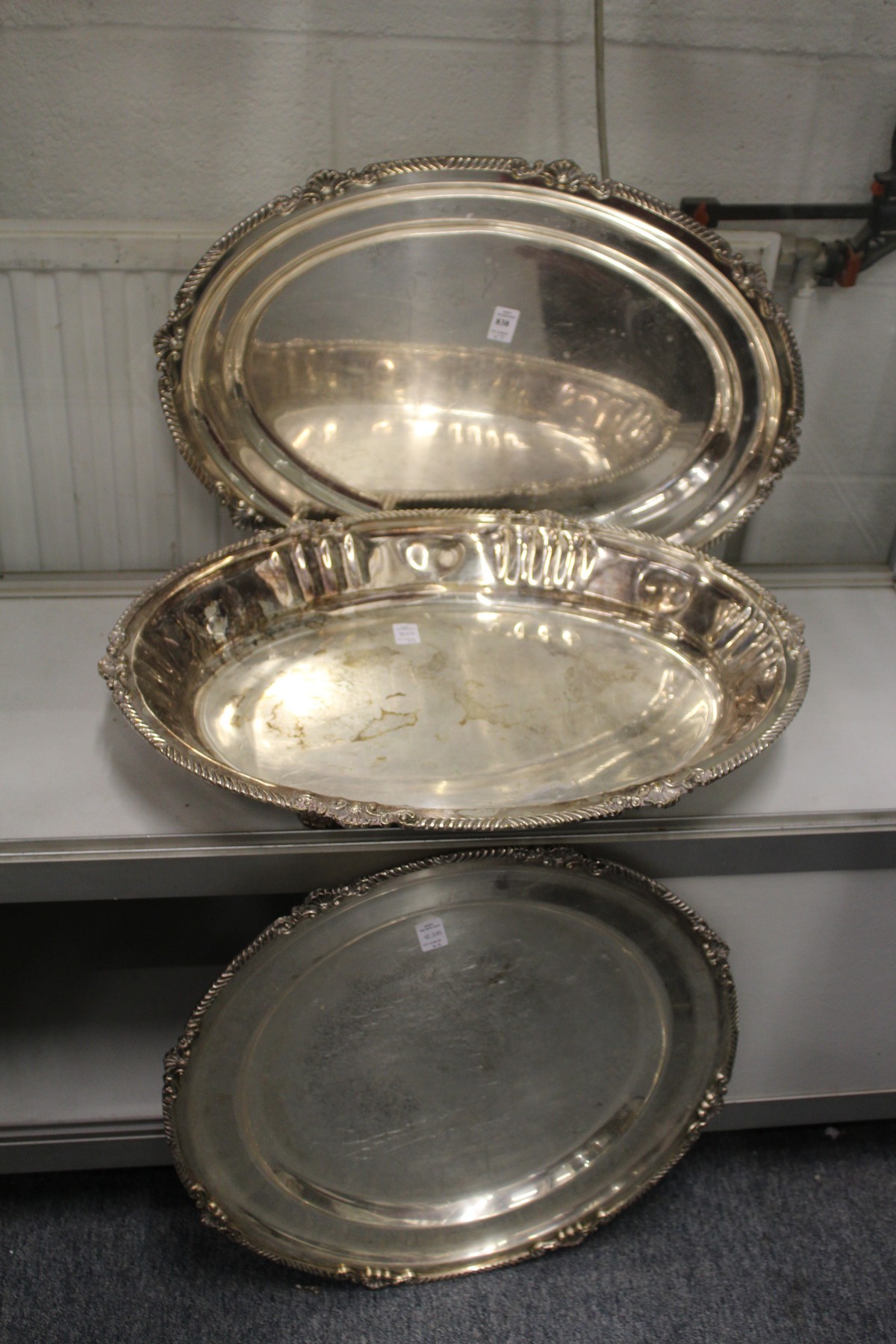 A large plated oval tray with similar dish and circular tray.