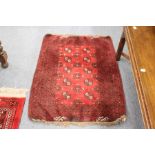 A small Persian Bokhara style rug.