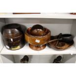 A turned wood nut bowl, a carved wood bowl and other wooden items.