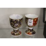 A pair of Imari decorated porcelain pedestal cups.