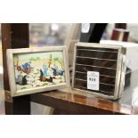 A silver cigarette box and photograph frame.