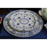 Three blue and white oval serving dishes.