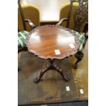 A Chippendale style miniature mahogany tilt top tripod table.