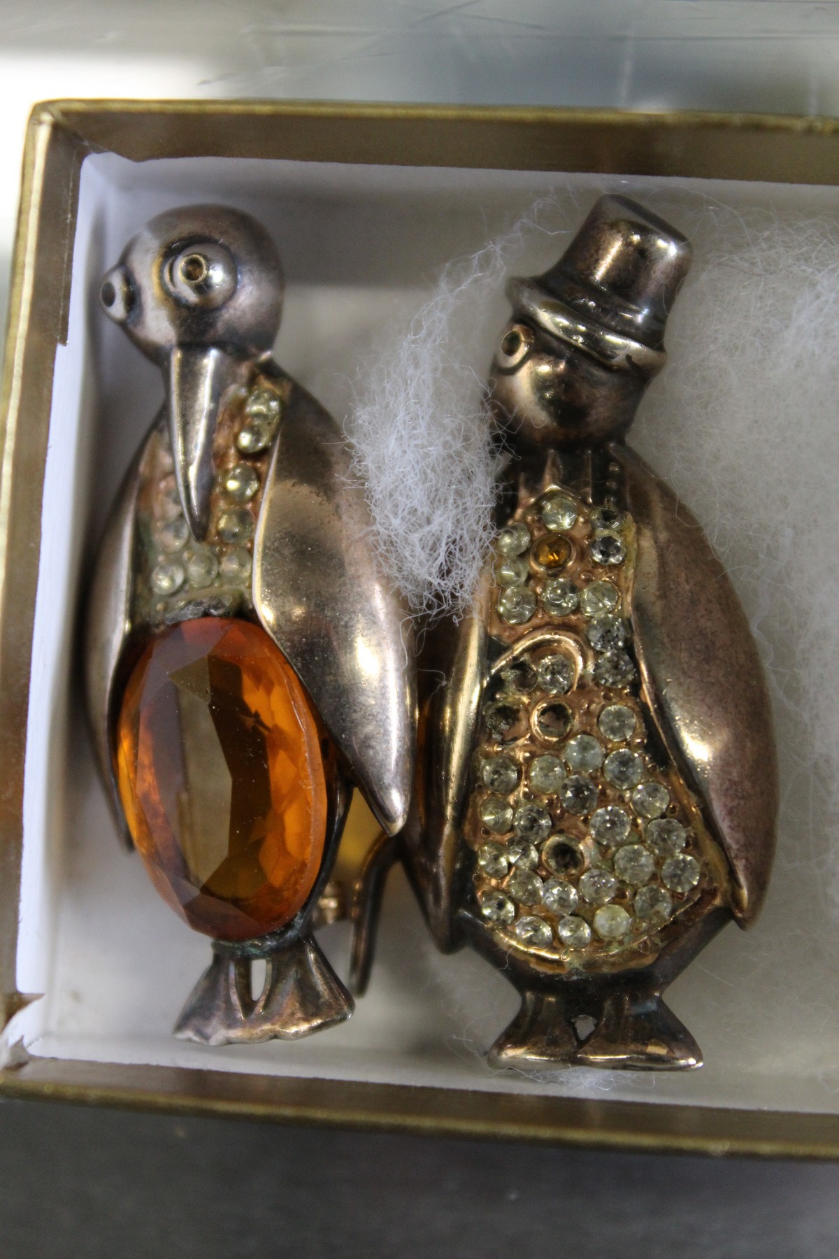 Two novelty penguin brooches.