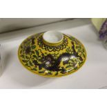 A Chinese famille jaune porcelain dragon bowl and cover.