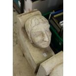 A large reconstituted stone human head corbel.