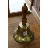 A brass hand bell.