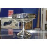 A silver pedestal dish with pierced decoration.