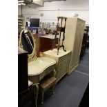 A four piece cream painted bedroom suite comprising wardrobe, chest of drawers, dressing table and