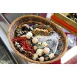 A basket containing numerous bead necklaces.