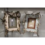 A pair of decorative photograph frames, the frames moulded with birds on branches.