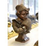 A good large continental bronze glazed pottery bust of a young girl, her hands in a muff.