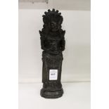 A dark patinated bronze figure of an eastern deity.