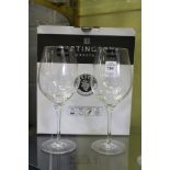 A boxed pair of Dartington crystal wine glasses.