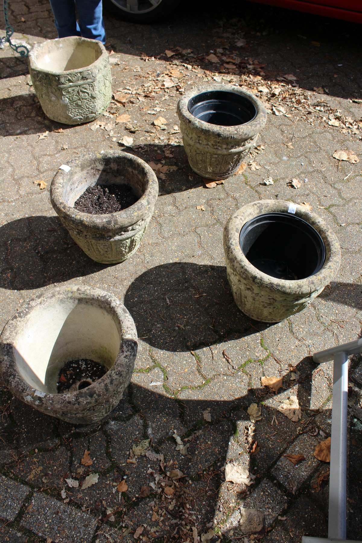 A set of four reconstituted stone garden pots.