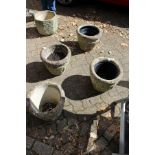 A set of four reconstituted stone garden pots.