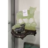 A Chinese carved jadeite group of a water buffalo and cart, on a hardwood stand.