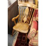 A Victorian beech and elm Windsor rocking chair with arms.