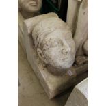 A large reconstituted stone human head corbel.