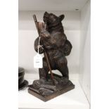 A good Black Forest style carved wood model of a hiking bear.