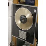 A novelty gold disc, framed and glazed.